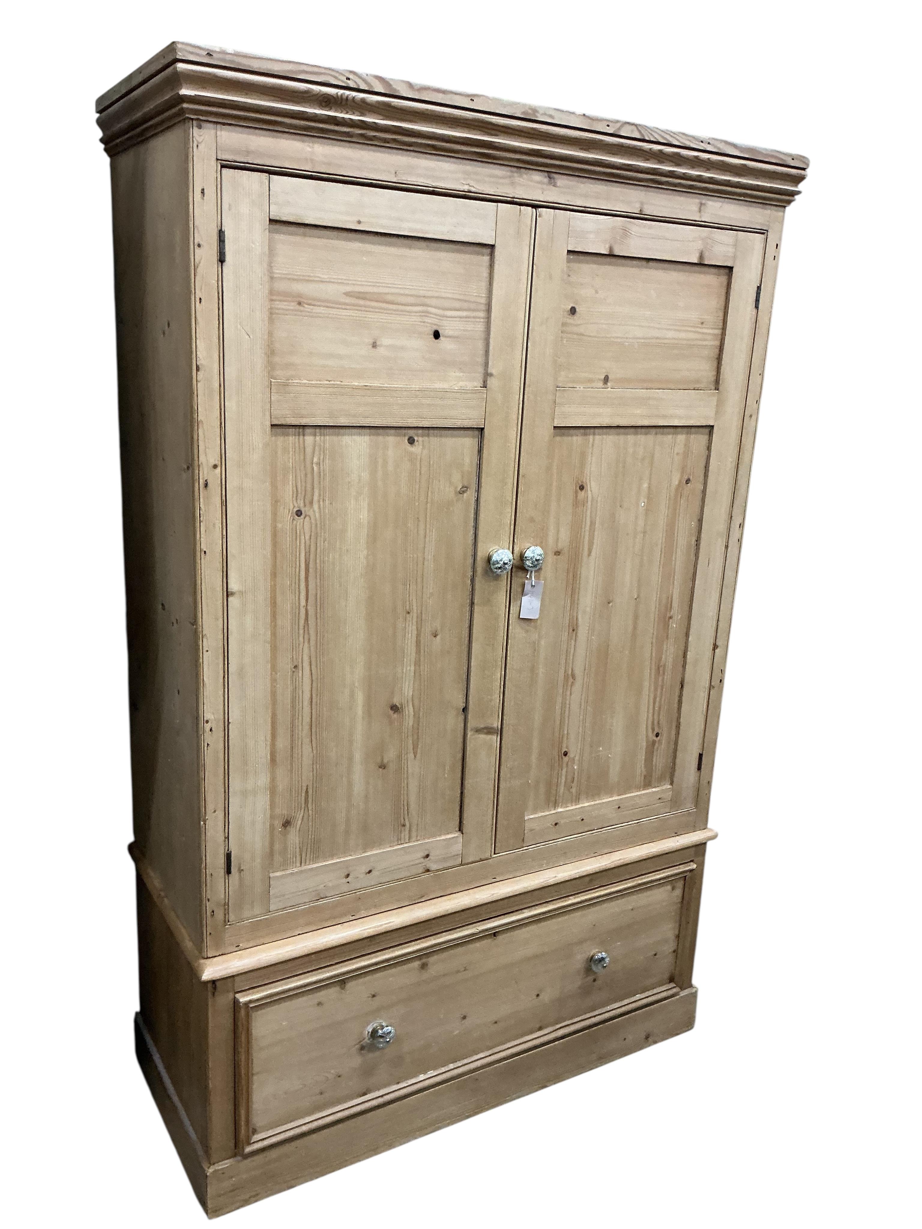 A late Victorian panelled pine two door wardrobe, width 114cm, depth 50cm, height 185cm